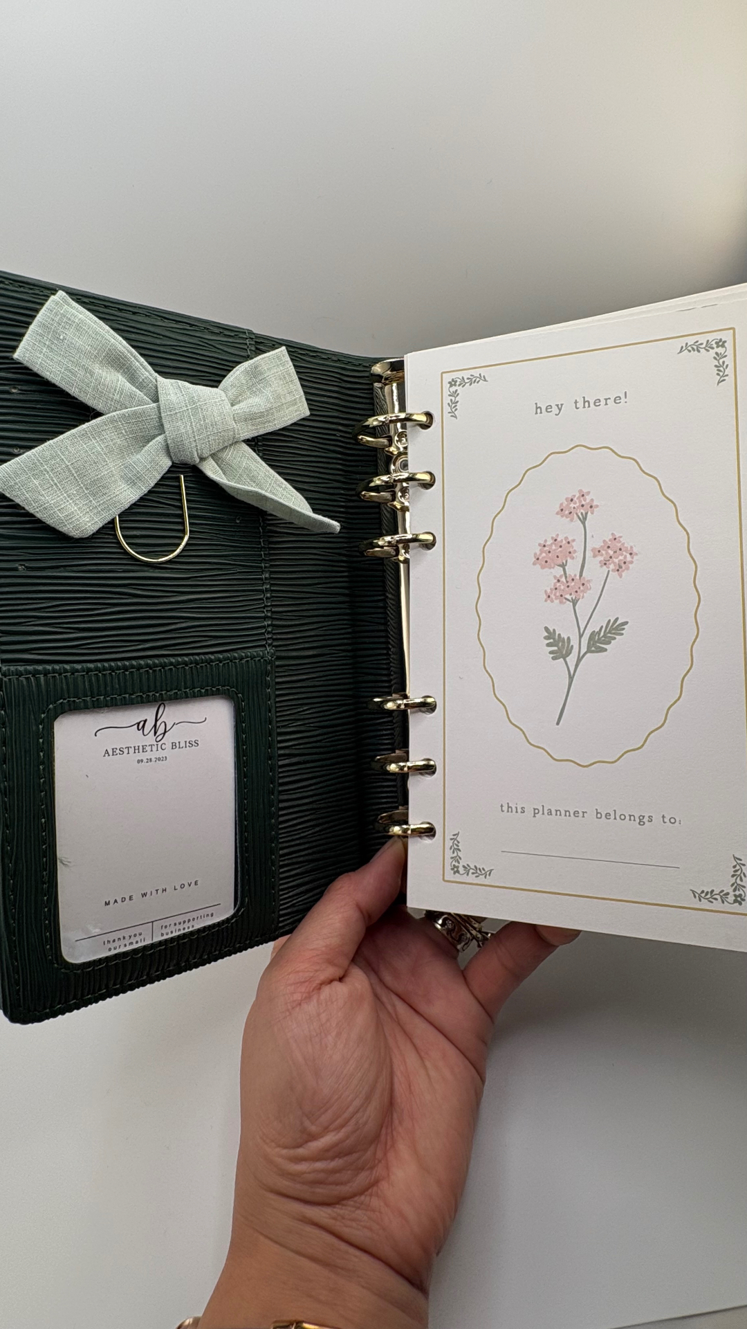 Deep olive binder with a sage linen bow clip and clear card pocket